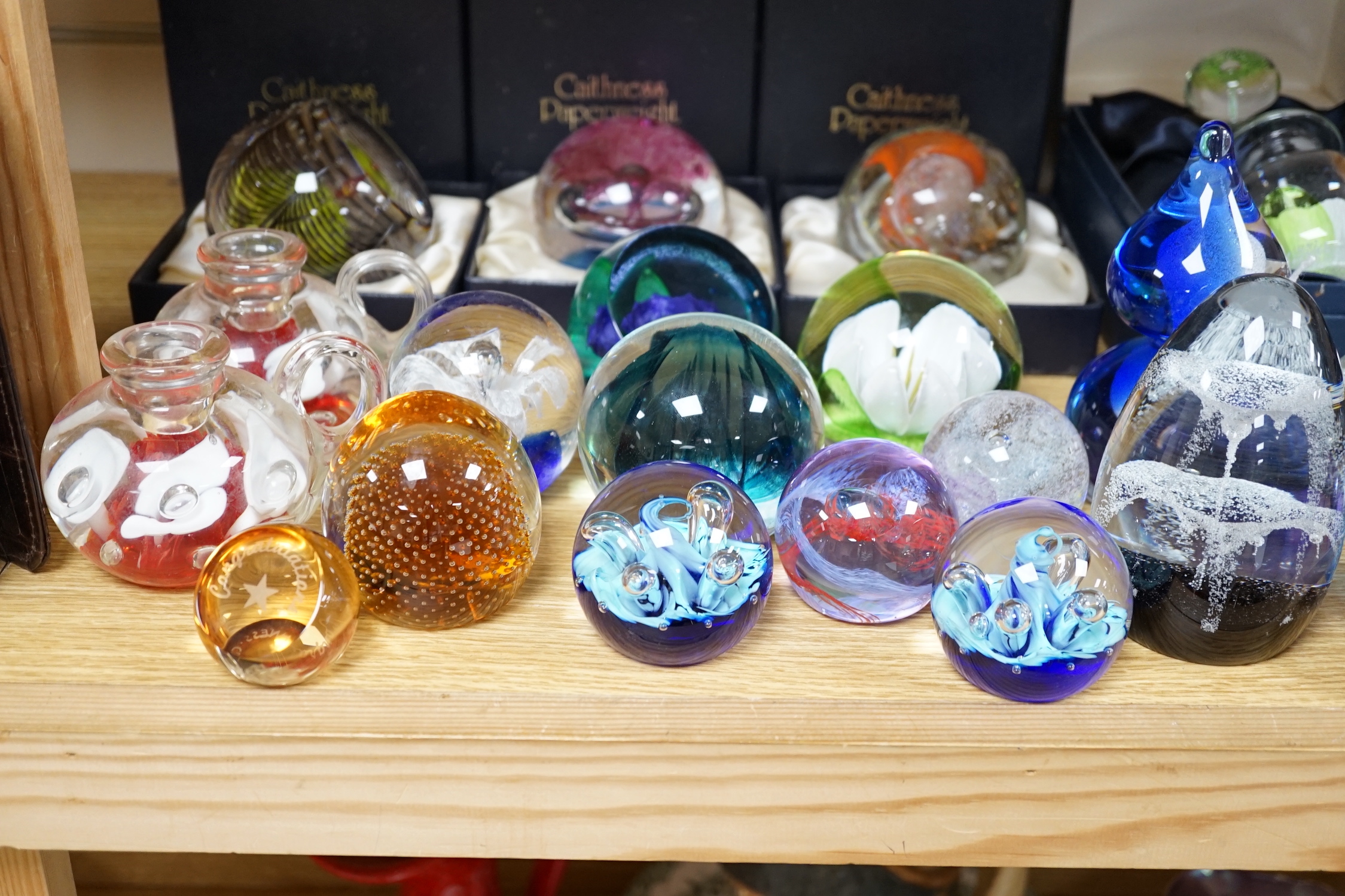 A collection of mostly Caithness glass paperweights, 1980s-2000s, with various boxes